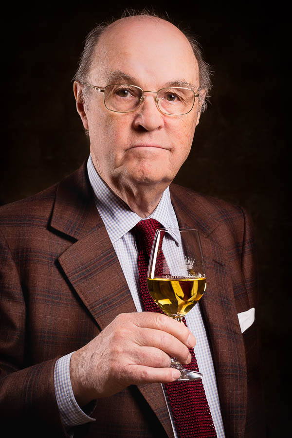 Portrait en studio du comte Alexandre de Lur Saluces un verre de vin à la main