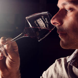 Photo d'un vigneron dégustant un verre du vin de sa propriété réalisée en studio professionnels